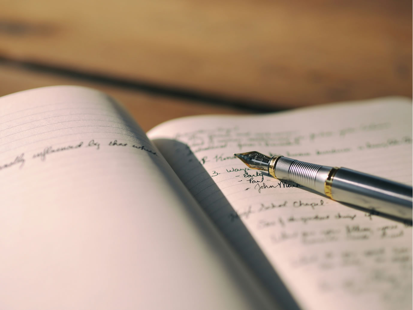 Notebook and pen on a warm-toned desk